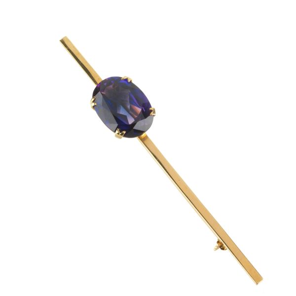 BARRETTE BROOCH WITH A VIOLET STONE IN 18KT YELLOW GOLD