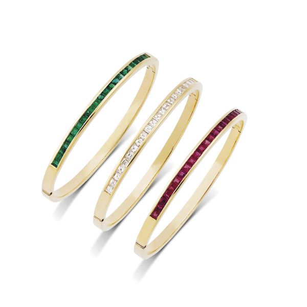 THREE RUBY EMERALD AND DIAMOND BANGLE BRACELETS IN 18KT YELLOW GOLD