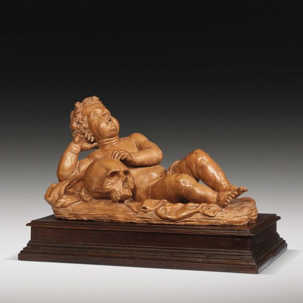 Rome, 17th century, A putto resting on a skull, patinated terracotta, 30x52x22 cm