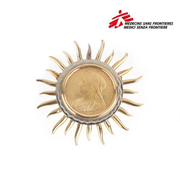 SUN-SHAPED PENDANT/BROOCH IN 18KT TWO TONE GOLD WITH A POUND