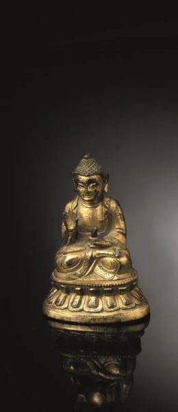 Scultura Cino-Tibetana, sec. XVII - XVIII, in bronzo dorato raffigurante Buddha assiso in dhyanasana, su doppia base a fior di loto, la mano destra in abhayamudra e la sinistra reggente la coppa della medicina, iscrizione sul retro, alt. cm 9