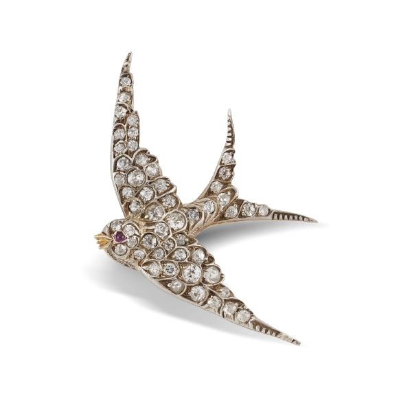 SWALLOW-SHAPED RUBY AND DIAMOND BROOCH IN GOLD AND SILVER