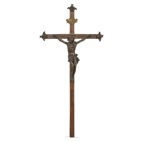Tuscan, 17th century, Crucified Christ, patined bronze, 43x35,5 cm, mounted on a mahogany cross enriched with bronze,  embossed and gilded copper applications, 119x57,5 cm (overall)