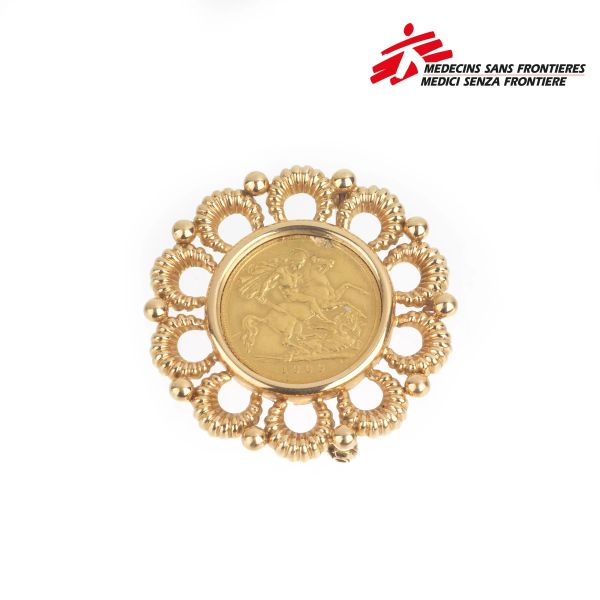 18KT YELLOW GOLD BROOCH WITH A POUND