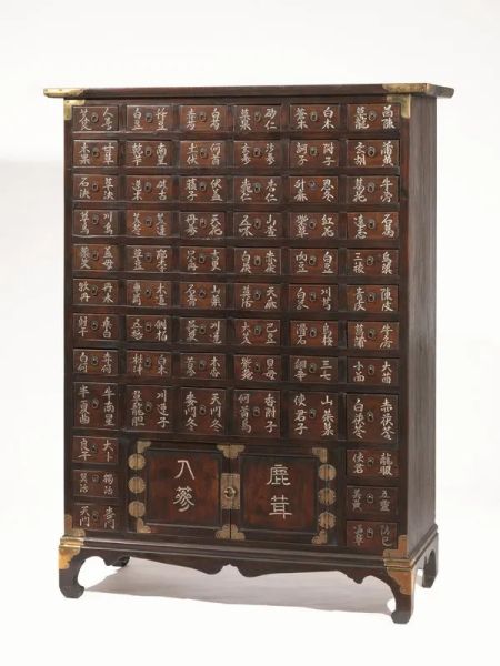  Mobile Cina sec. XIX - XX,  il fronte con piccoli cassetti e due sportelli in basso, serrature in metallo, ogni cassetto decorato con un carattere cinese, gambe unite da traverse, cm 115.5x47.5x155                             