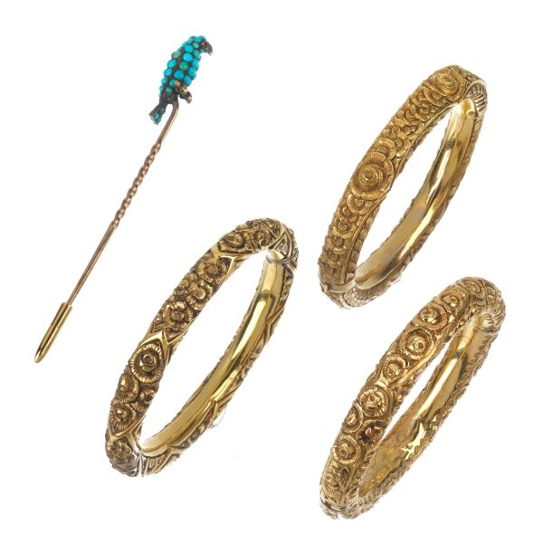 THREE BANGLE BRACELETS IN GOLD AND METAL WITH A PARROT PIN