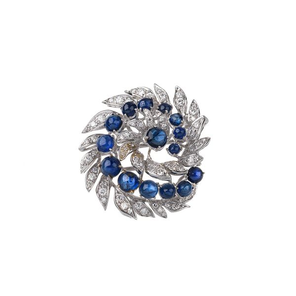 



SAPPHIRE AND DIAMOND PINWHELL BROOCH IN 18KT WHITE GOLD