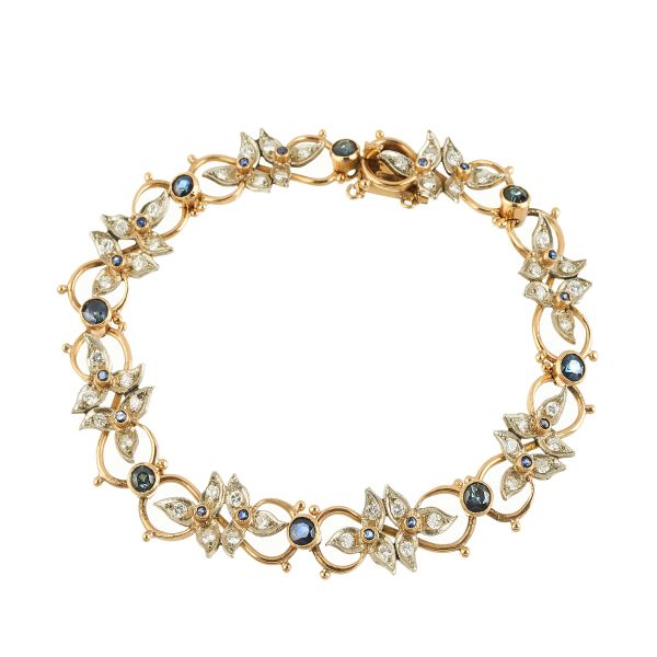 



SAPPHIRE AND DIAMOND FLOWERING BRANCH-SHAPED BRACELET IN 18KT TWO TONE GOLD 