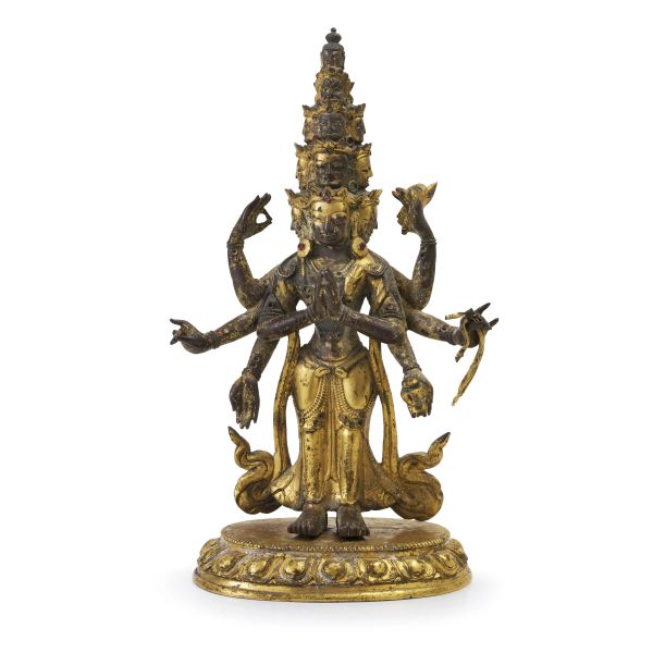A GILT-BRONZE FIGURE OF ELEVEN-HEADED AVALOKITESHVARA, TIBET OR TIBETO-CHINESE, 18TH-19TH CENTURY