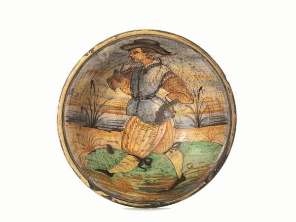 Piatto, Manifattura di Montelupo, sec. XIX, in maiolica policroma raffigurante un archibugiere in un paesaggio stilizzato, cm 31, difetti