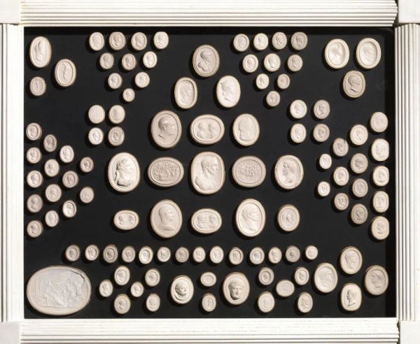  Trecentodue piccoli calchi di cammei, sec. XIX , tratti dall'antico, in gesso, entro tre cornici in legno laccato bianco, cm 44x54 (3)                                                             