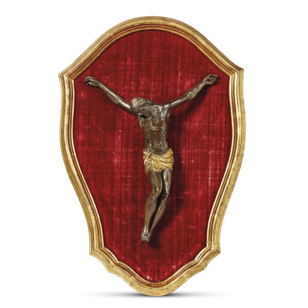 Tuscany, late 17th century, A Cross, bronze, 27x20,5 cm on a panel covered by red velvet, 43x28,5 cm