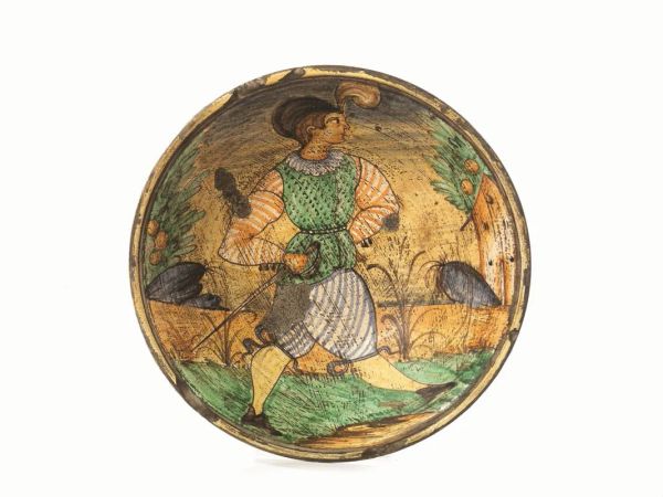 Piatto, Manifattura di Montelupo, sec. XIX, in maiolica policroma raffigurante un soldato con sciabola in un paesaggio stilizzato, cm 31, difetti