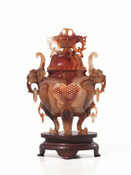 Vaso con coperchio, Cina sec. XX, in agata finemente intagliata e lavorata al traforo, poggiante su base in legno alt. cm 22,5