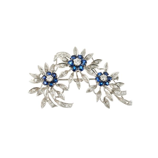 



SAPPHIRE AND DIAMOND FLOWERING BRANCH-SHAPED BROOCH IN 18KT WHITE GOLD