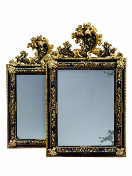 PAIR OF MIRRORS, VENICE, SECOND QUARTER OF THE 18TH CENTURYPAIR OF MIRRORS, VENICE, SECOND QUARTER OF THE 18TH CENTURY  in ebonized, lacquered and gilded wood with mother of pearl marquetry and foliage in sculpted and gilded wood, 168x98 cm  This pair of frames is a typical and refined expression of the early rococo atmosphere in Venice during the second quarter of the 18th century. This was a moment in time in which the gilded mirror passed from being mostly used for private grooming to constituting a furnishing element in its own right, over a progressive process of emancipation. During this still transitory phase, during which each city exhibited its own decorative techniques, Venice became one of the main protagonists, laying the foundation for a decorative style that will constitute a key influence for the coming decades.  Over the course of the 18th century, the creation of these artefacts is so deeply rooted in the venetian lagoon that within the guild of the marangoni, or woodworkers, there developed a specific branch of highly specialized master carvers, the marangoni de soaza. At the same time, there was a multiplication of workshops managed by soaza artisans: 36 workshops with 94 masters, 124 workers and 24 helpers according to a 1773 statistic polled by the magistrates and trade regulators of the Savi della Mercanzia. The venetian masters did not shy away from letting their creativity run loose, using an ornamentation technique at which they excelled, enamelling, in which the decoration, drawn on a monochrome stucco base is then polished with a layer of varnish, called sandracca. It was in this way that the same kinds of ornamentations which decorated chests and other furnishings went on to embellish mirror-frames, animating them with exotic themes, or chinoiserie. A particular predilection is reserved for decorations modelled after flowers and of oriental inspiration which, drawn vividly and with narrative gusto, stand out with their rich colours against the neutral, often dark backgrounds, alternated with branches and leaves and creating an exuberant but at the same time composedly elegant picture. When a given commission is particularly important, these decorations may also be further enriched by evocative pearl inlays, as with the red and gold lacquered wood frame made in Venice at the end of the 17th century and currently held in the Gemäldegalerie in Berlin (fig. 1), or the one probably dating from the early 18th century and held in a private collection (fig. 2). It is also the case of our two frames, which were probably requested by an important family for a significant occasion. The combination of lacquer and pearl was a venetian prerogative between the late 17th and early 18th centuries. Many carvers produced this kind of decoration, among whom we must mention the architect, engraver, carver, and inlayer Domenico Rossetti, famous for his “works with pearl and in the Chinese style”.  This pictorial richness was paralleled by an equal sculptural vivacity, which expressed itself – as well as in the creation of frames in a wide array of styles and shapes – in adding further elements of carved wood to the frames. Additions in sculpted and gilded wood are often attached to the four outer corners of the frame. We can see this in our pair’s ogival motif, creating a kind of counter-frame which was supposed to make the mirror stand out against the wall. But a greater importance is without doubt given to the coping, a necessary crowning of the upper part of the mirror. In the carving of this component, the venetian masters let their creative imagination run wild, showing off their whole repertory of leaves, shells, festoons, and, as in the present case, cartouches, often made so that they would hold a family crest or, as is the case here, decorated with the same pictorial motifs embellished with pearl that are found on the main body of the frame.  Almost as if replying to the painted floral motifs, the coping is populated by elements in painted and carved wood, made with a mastery fully on par with that of the expert and imaginative master painters. In our mirror-frames, flower and fruit alternated with leafy folds frame the central coping, the asymmetrical position of which creates a decentred effect typical of the 18th century, whilst the four corners of the frames are marked – symmetrically this time – by small sculpted and polished folders in the middle of the pearl component. And whilst often in this kind of mirror-frame the sculptural element tends to dominate over the pictorial one, concentrating the focal point of attention on the coping, here the overall composition is characterized by a marked equilibrium, in which all elements, both sculptural and pictorial, cohabit and form a harmonious whole.  In this sense, these mirror-frames can be fully included in early rococo production, when the festive and daring baroque evolved into lines which – whilst still dominated by an inventive force and capricious exuberance – reflected the period’s more graceful and refined taste. During these few years, many sculptors and woodcarvers place their art in the service of frame-making, including Antonio Gai, Antonio Corradini, or Andrea Brustolon, noted for having made multiple frames alongside the furnishings for the Venier family, now held in Palazzo Rezzonico. Following his drawing, the luxurious throne for the church of the Gesuati in Venice was made in the early 18th century (fig. 3). Its precious pearl inlays, together with its folds and rich wooden sculpted and gilded flowers, constitute one of the first examples of a decorative taste which will exercise much influence over the following decades. Our mirror-frames, thus, may be included precisely in this current.   Comparative literature G. Mariacher, Specchiere italiane e cornici da specchio, dal XV al XIX secolo, Milan 1963, pp. 16-24; E. Colle, Il mobile barocco in Italia, Milan 2000, p. 332; C. Santini, Mille mobili veneti. L’arredo domestico in Veneto dal sec. XV al sec. XIX, III, Modena 2002, pp. 246-247 nn. 424-426                PAIR OF MIRRORS, VENICE, SECOND QUARTER OF THE 18TH CENTURY  in ebonized, lacquered and gilded wood with mother of pearl marquetry and foliage in sculpted and gilded wood, 168x98 cm  This pair of frames is a typical and refined expression of the early rococo atmosphere in Venice during the second quarter of the 18th century. This was a moment in time in which the gilded mirror passed from being mostly used for private grooming to constituting a furnishing element in its own right, over a progressive process of emancipation. During this still transitory phase, during which each city exhibited its own decorative techniques, Venice became one of the main protagonists, laying the foundation for a decorative style that will constitute a key influence for the coming decades.  Over the course of the 18th century, the creation of these artefacts is so deeply rooted in the venetian lagoon that within the guild of the marangoni, or woodworkers, there developed a specific branch of highly specialized master carvers, the marangoni de soaza. At the same time, there was a multiplication of workshops managed by soaza artisans: 36 workshops with 94 masters, 124 workers and 24 helpers according to a 1773 statistic polled by the magistrates and trade regulators of the Savi della Mercanzia. The venetian masters did not shy away from letting their creativity run loose, using an ornamentation technique at which they excelled, enamelling, in which the decoration, drawn on a monochrome stucco base is then polished with a layer of varnish, called sandracca. It was in this way that the same kinds of ornamentations which decorated chests and other furnishings went on to embellish mirror-frames, animating them with exotic themes, or chinoiserie. A particular predilection is reserved for decorations modelled after flowers and of oriental inspiration which, drawn vividly and with narrative gusto, stand out with their rich colours against the neutral, often dark backgrounds, alternated with branches and leaves and creating an exuberant but at the same time composedly elegant picture. When a given commission is particularly important, these decorations may also be further enriched by evocative pearl inlays, as with the red and gold lacquered wood frame made in Venice at the end of the 17th century and currently held in the Gemäldegalerie in Berlin (fig. 1), or the one probably dating from the early 18th century and held in a private collection (fig. 2). It is also the case of our two frames, which were probably requested by an important family for a significant occasion. The combination of lacquer and pearl was a venetian prerogative between the late 17th and early 18th centuries. Many carvers produced this kind of decoration, among whom we must mention the architect, engraver, carver, and inlayer Domenico Rossetti, famous for his “works with pearl and in the Chinese style”.  This pictorial richness was paralleled by an equal sculptural vivacity, which expressed itself – as well as in the creation of frames in a wide array of styles and shapes – in adding further elements of carved wood to the frames. Additions in sculpted and gilded wood are often attached to the four outer corners of the frame. We can see this in our pair’s ogival motif, creating a kind of counter-frame which was supposed to make the mirror stand out against the wall. But a greater importance is without doubt given to the coping, a necessary crowning of the upper part of the mirror. In the carving of this component, the venetian masters let their creative imagination run wild, showing off their whole repertory of leaves, shells, festoons, and, as in the present case, cartouches, often made so that they would hold a family crest or, as is the case here, decorated with the same pictorial motifs embellished with pearl that are found on the main body of the frame.  Almost as if replying to the painted floral motifs, the coping is populated by elements in painted and carved wood, made with a mastery fully on par with that of the expert and imaginative master painters. In our mirror-frames, flower and fruit alternated with leafy folds frame the central coping, the asymmetrical position of which creates a decentred effect typical of the 18th century, whilst the four corners of the frames are marked – symmetrically this time – by small sculpted and polished folders in the middle of the pearl component. And whilst often in this kind of mirror-frame the sculptural element tends to dominate over the pictorial one, concentrating the focal point of attention on the coping, here the overall composition is characterized by a marked equilibrium, in which all elements, both sculptural and pictorial, cohabit and form a harmonious whole.  In this sense, these mirror-frames can be fully included in early rococo production, when the festive and daring baroque evolved into lines which – whilst still dominated by an inventive force and capricious exuberance – reflected the period’s more graceful and refined taste. During these few years, many sculptors and woodcarvers place their art in the service of frame-making, including Antonio Gai, Antonio Corradini, or Andrea Brustolon, noted for having made multiple frames alongside the furnishings for the Venier family, now held in Palazzo Rezzonico. Following his drawing, the luxurious throne for the church of the Gesuati in Venice was made in the early 18th century (fig. 3). Its precious pearl inlays, together with its folds and rich wooden sculpted and gilded flowers, constitute one of the first examples of a decorative taste which will exercise much influence over the following decades. Our mirror-frames, thus, may be included precisely in this current.   Comparative literature G. Mariacher, Specchiere italiane e cornici da specchio, dal XV al XIX secolo, Milan 1963, pp. 16-24; E. Colle, Il mobile barocco in Italia, Milan 2000, p. 332; C. Santini, Mille mobili veneti. L’arredo domestico in Veneto dal sec. XV al sec. XIX, III, Modena 2002, pp. 246-247 nn. 424-426                