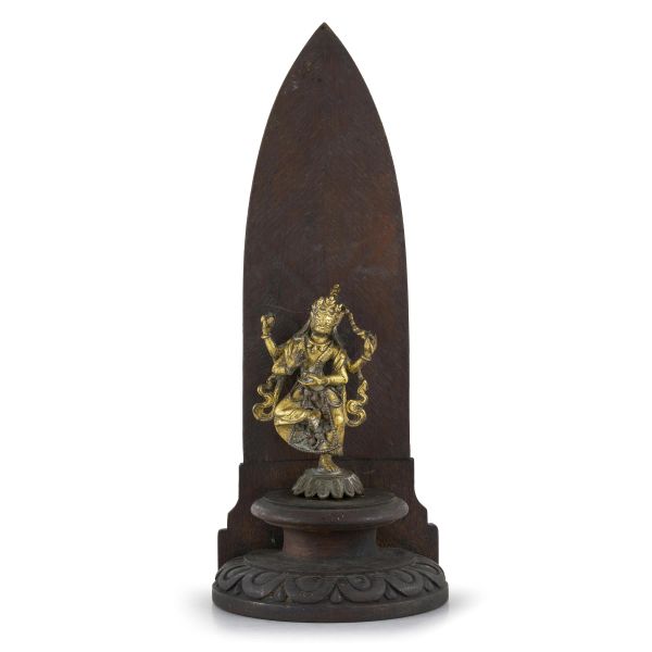



A GILT BRONZE DEITY FIGURE ON WOODEN MANDORLA, TIBET, 19TH CENTURY